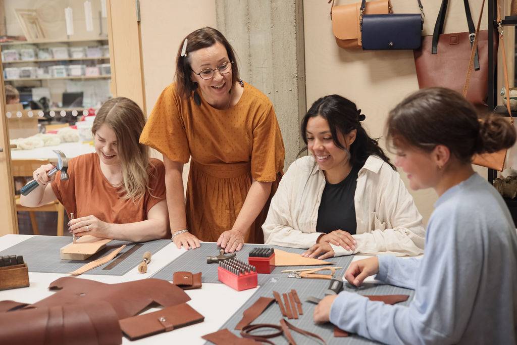 A group of people making handycrafts of leather