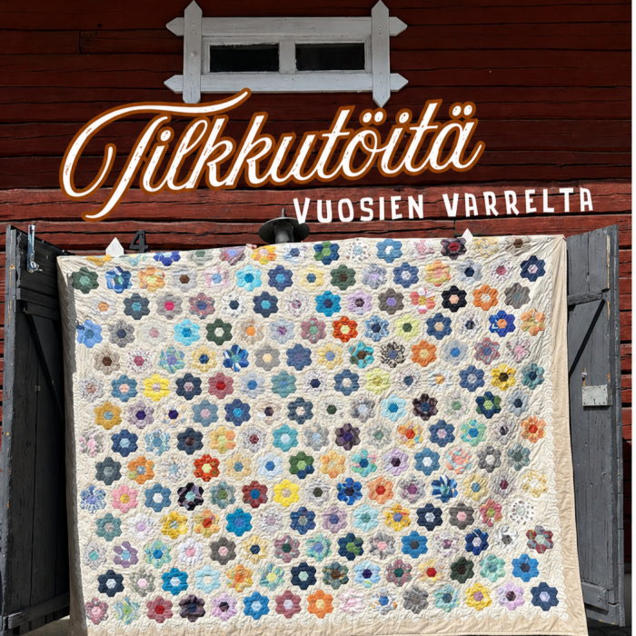 Tilkkutöitä vuosien varrelta -teksti ja iso tilkkupeitto